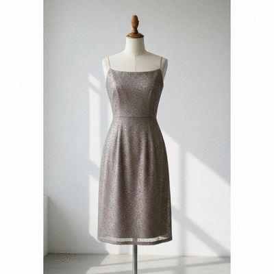 Elegant knee-length cocktail dress displayed on a mannequin in a bright studio